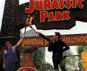 Steven Spielberg and Jeff Goldblum light the torches on the Jurassic Park Gates (photo courtesy of JPLegacy.org)