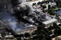 2008 Fire - smouldering remains of the King Kong soundstage in the foreground as the fire continues to rage in the video vaults - AP photo by Kevork Djansezian - from Chicago Tribune