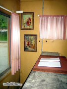 The motel front desk. The TV just behind the front desk is showing a promotional film featuring Hitchcock himself, made for the original Psycho release. (2005)