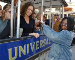 Whoopi Goldberg greets guests on the tram