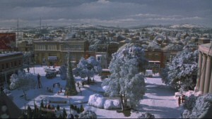 Gremlins - Stills - 1 - Still from the opening of the movie featuring a gorgeous matte painting of the town of Kingston Falls, featuring Courthouse Square in the foreground.