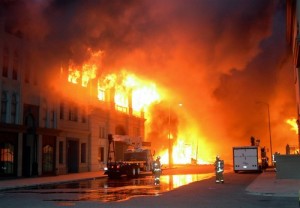 A studio set is engulfed in fire as fire fighters work to extinguish the burning set in the early hours at Universal Studios in Los Angeles, Sunday June 1, 2008. A large fire tore through a back lot at Universal Studios early Sunday, destroying a set from "Back to the Future," the King Kong exhibit and thousands of videos and reels in a vault. (AP Photo/Mike Meadows) ORG XMIT: LA114